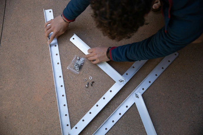 a person is working on a metal frame